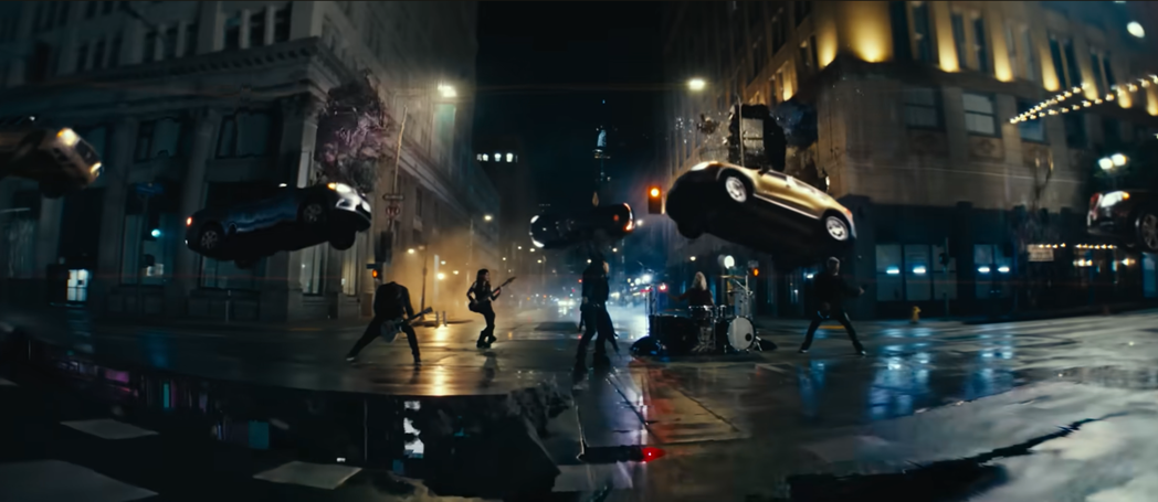 Evanescence band playing in a city intersection as cars levitate overhead in Who Will You Follow.
