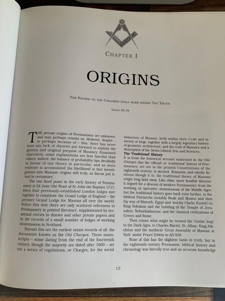 Book page showing the opening of Chapter I titled "ORIGINS" with introductory text about Masonic history and a square and compass symbol.